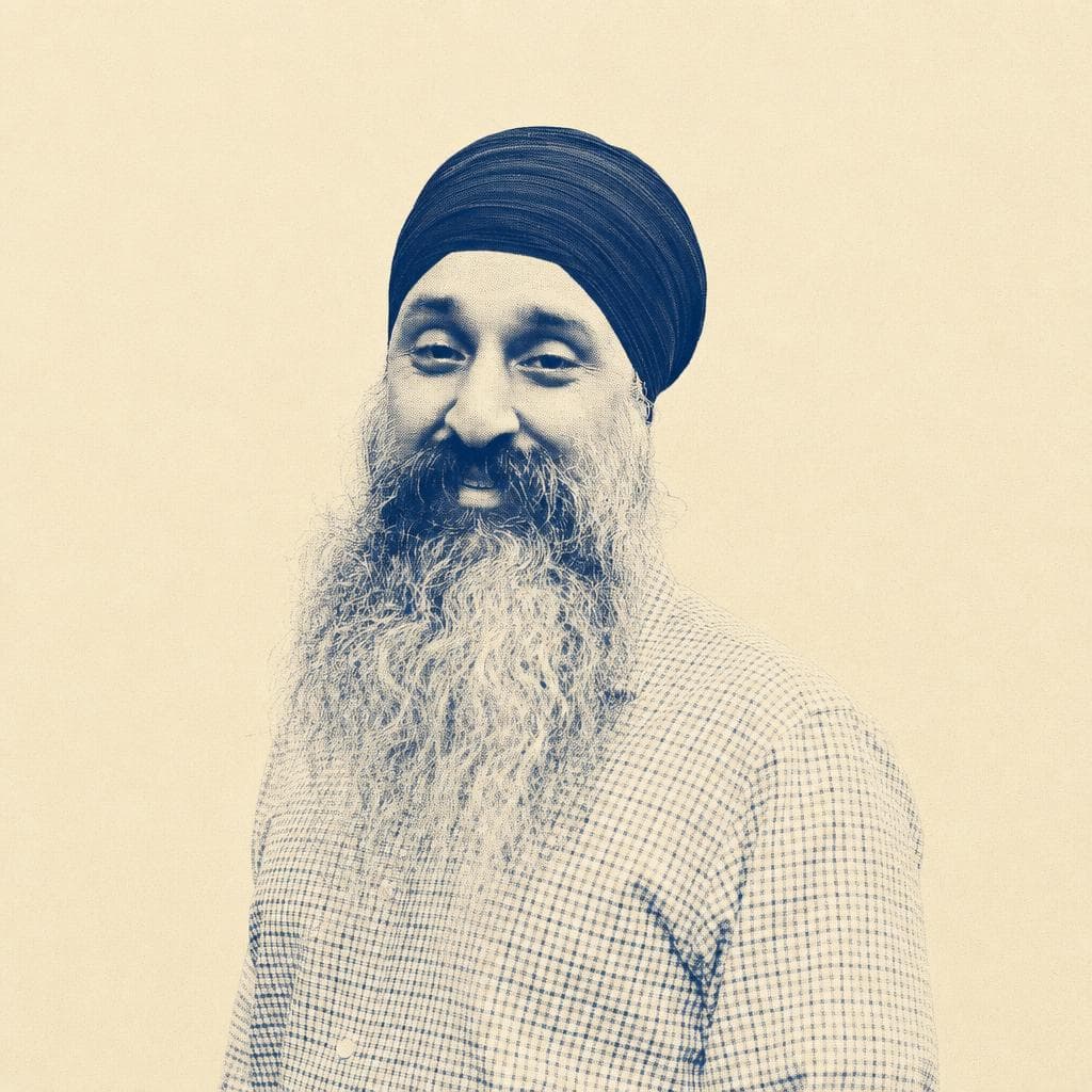 Inderpal Singh, in a navy dastar and checked shirt, photographed outdoors among autumn trees.