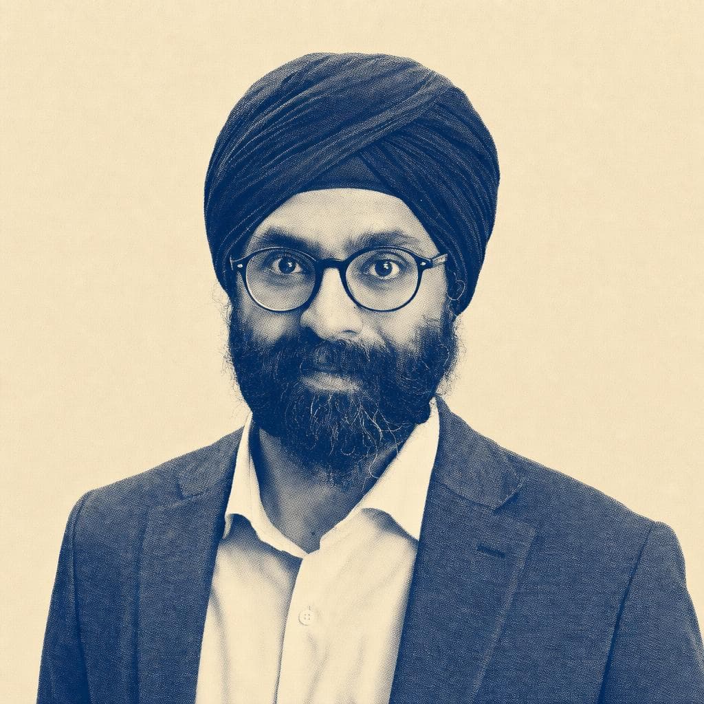 Karandeep Singh, in a navy dastar, glasses and grey blazer.
