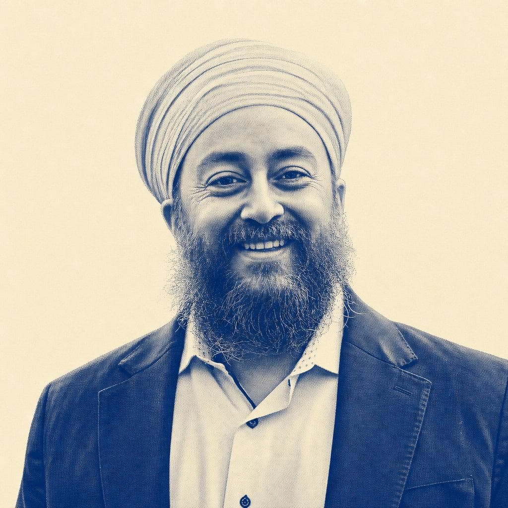 Narinder Singh, in a light grey dastar and navy blazer, photographed outdoors.